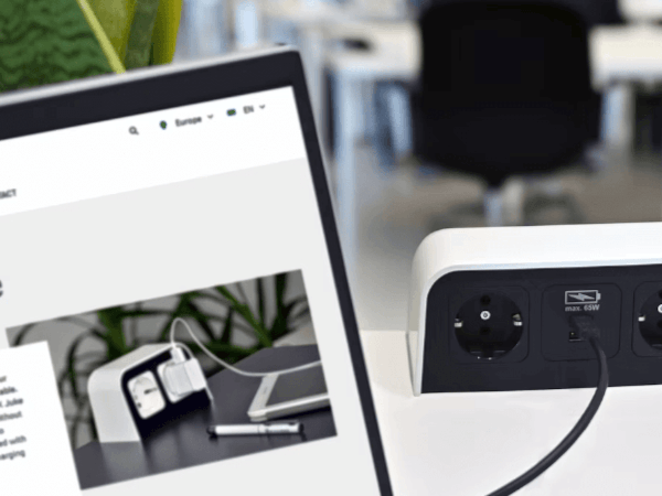 Whitney leaning against a railing on a downtown street