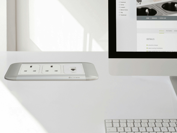 Whitney leaning against a railing on a downtown street