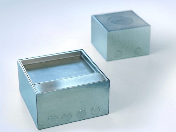 Whitney leaning against a railing on a downtown street